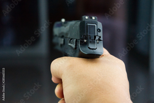Close up Hand shooting gun. © maew