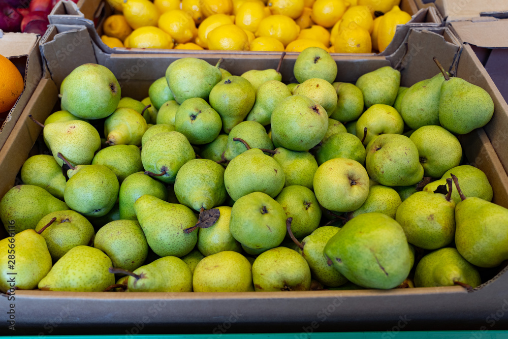 Fresh fruit, ripe pears on the counter in the supermarket