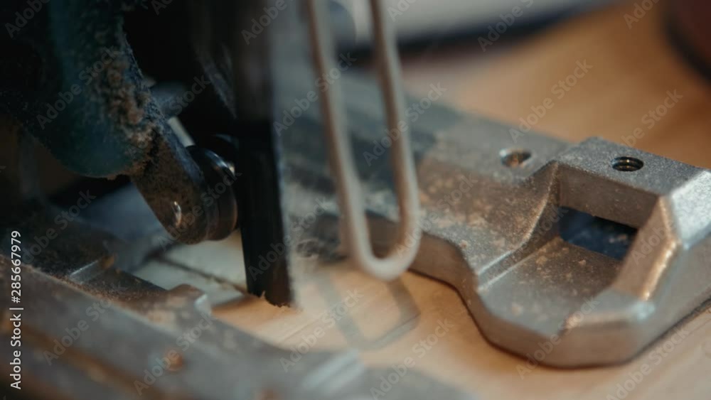 Close up of Carpenter's hands cutting wood with table saw in workshop, craftsman furniture Close up of Carpenter's hands cutting wood with table saw in workshop, craftsman furniture