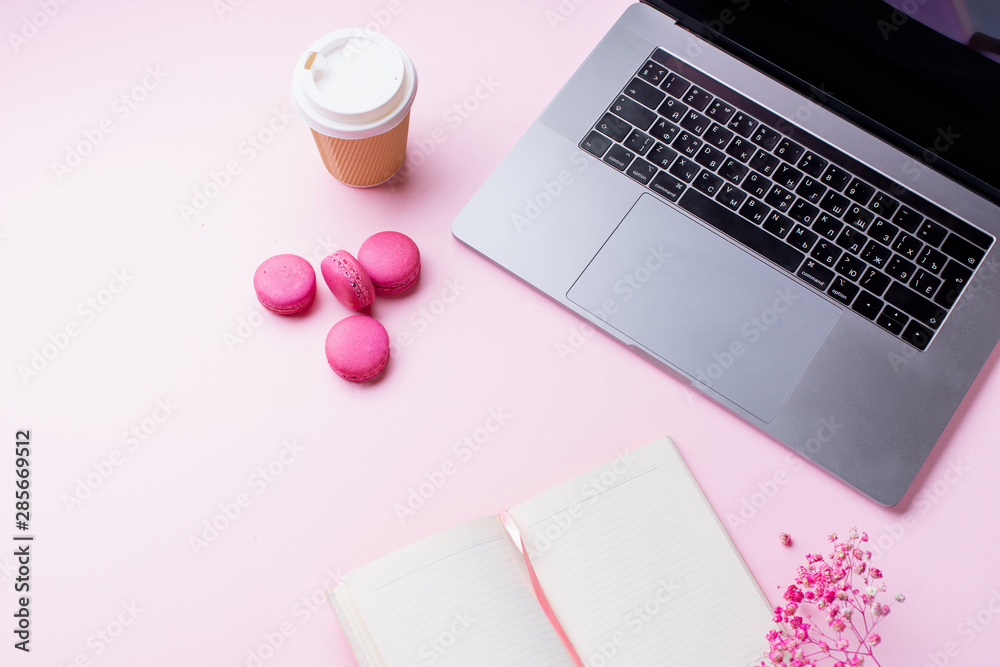 Flatlay with laptop, coffee and macarons on pink background. Top view, copy space. Workplace concept. Flatlay with laptop, coffee and macarons on pink background. Top view, copy space. Workplace concept.