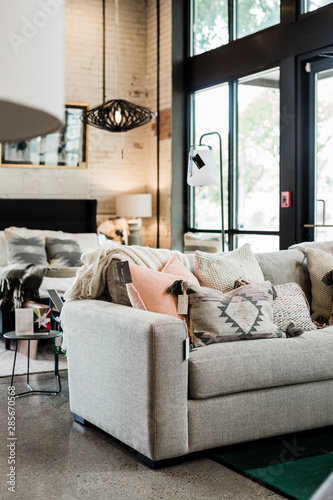 grey sofa with modern pillows, home furniture store