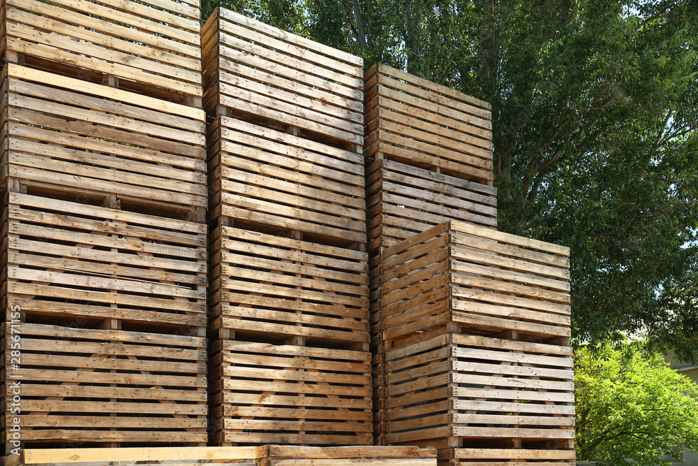 Pile of empty wooden crates outdoors on sunny day Pile of empty wooden crates outdoors on sunny day