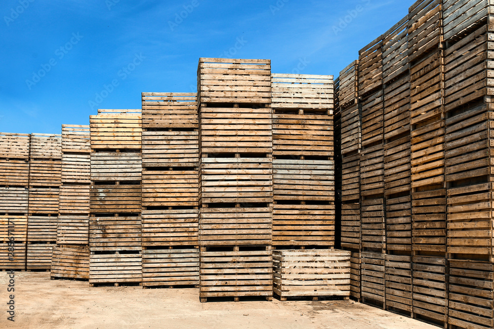 Pile of empty wooden crates outdoors on sunny day Pile of empty wooden crates outdoors on sunny day