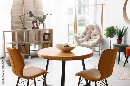 Modern dining room interior with table and chairs