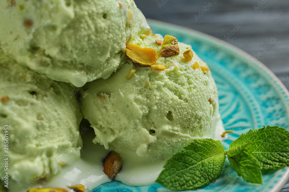 Delicious green ice cream served on blue plate, closeup Delicious green ice cream served on blue plate, closeup