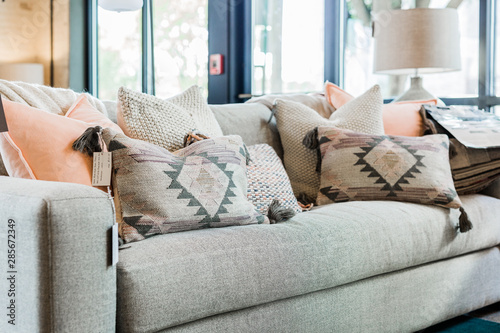 modern grey couch with pink and grey bohemian throw pillows  photo