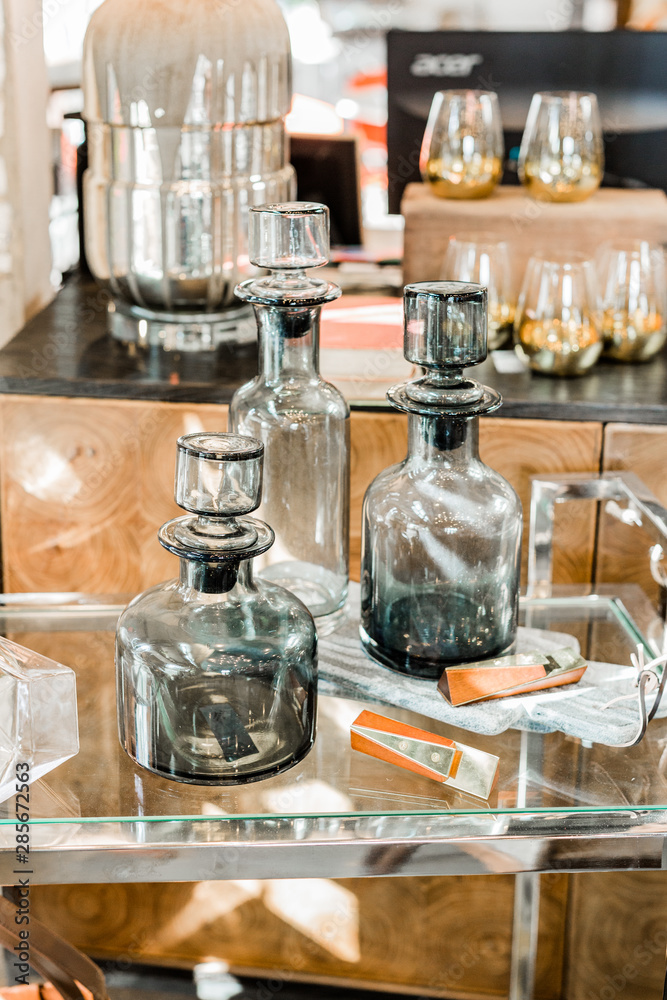 Modern bar cart with dark gray glass decanters Modern bar cart with dark gray glass decanters