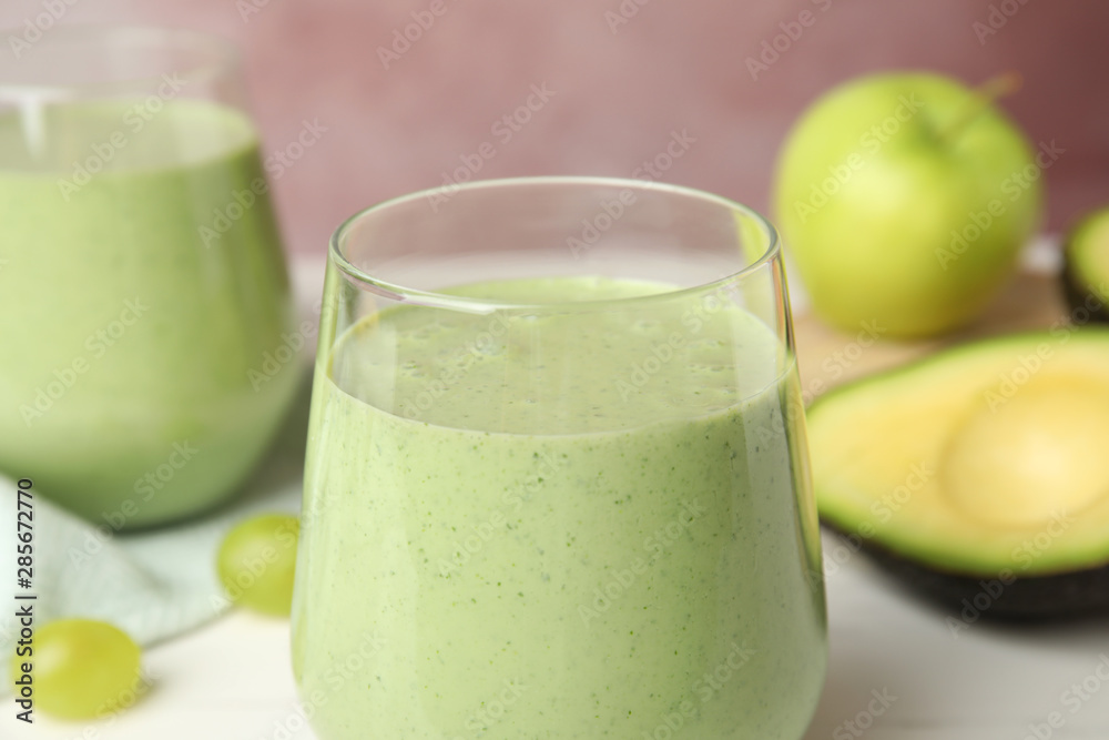 Glass of tasty avocado smoothie on table, closeup Glass of tasty avocado smoothie on table, closeup