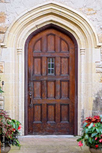 Old Wooden Door with Arched Doorway on Historic Stone Building