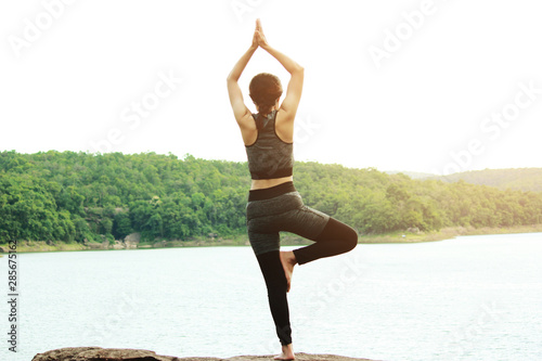 Healthy young woman exercising in sunny bright light. Sport exercise concept.