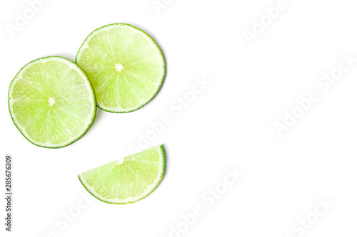 Smile of slices juicy green lime at the left side of image isolated on white background. Healthy food with copy space. Flat lay concept