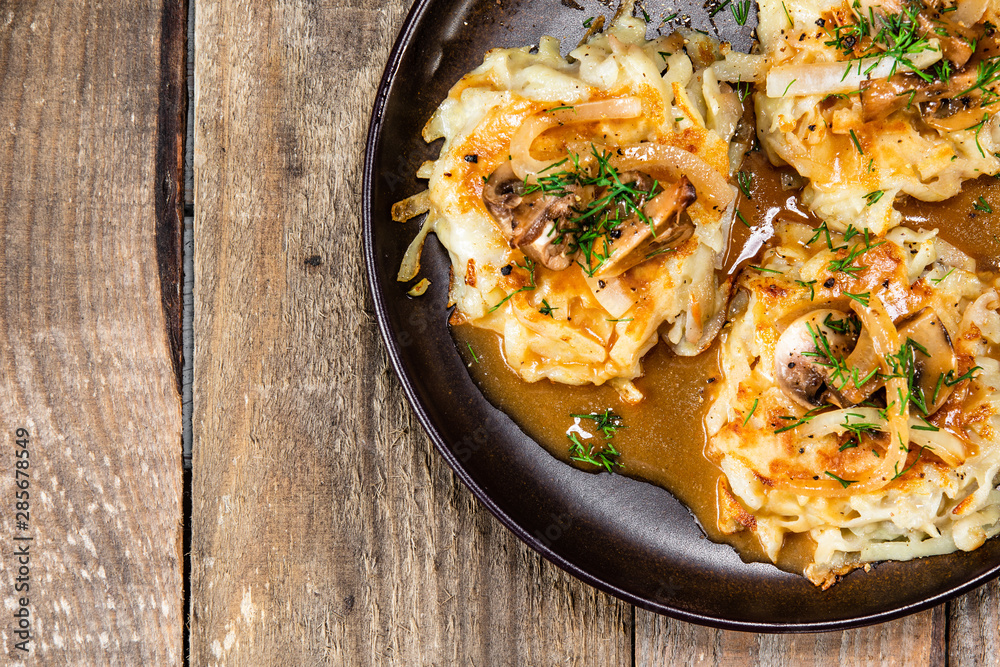 Wall Mural Potato cakes with gravy sauce and champignon
