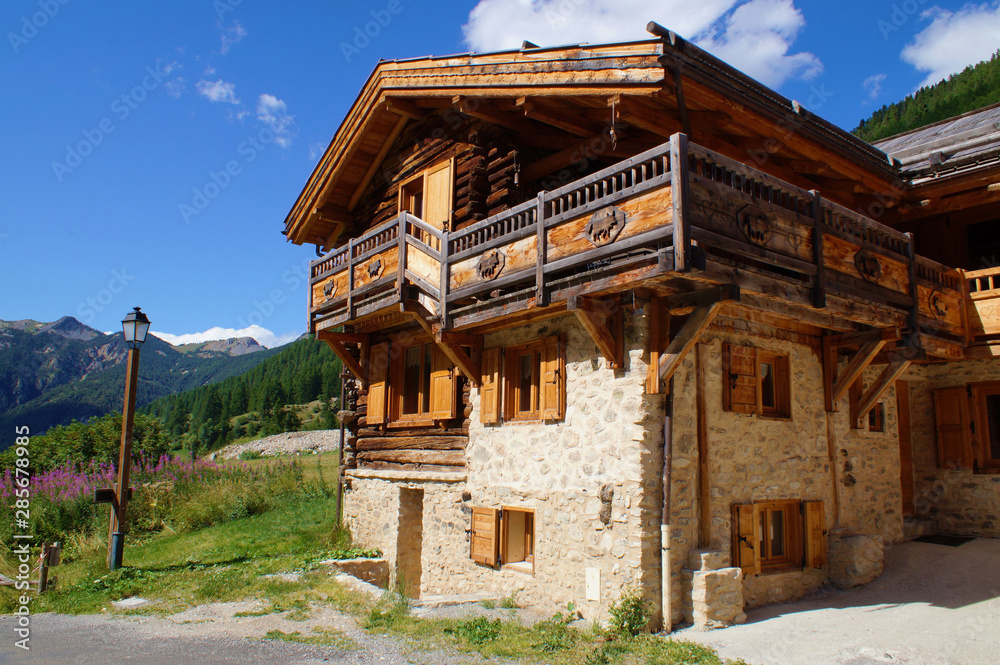 Mountain chalet with traditional architecture and décorated balconies  in a high village of the Alps, France