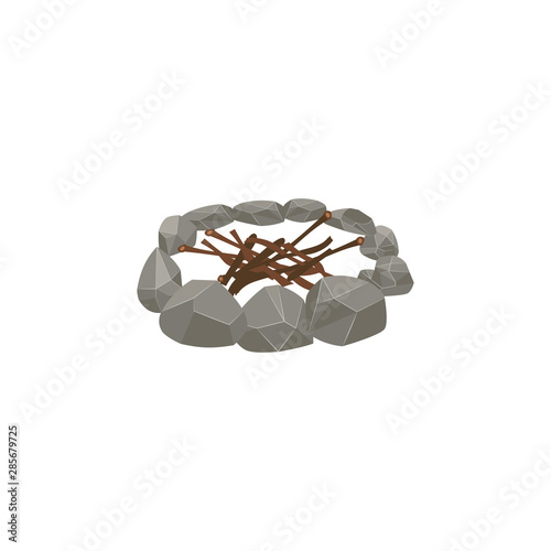Firewood sticks stacked inside circle of stones, bonfire preparation step