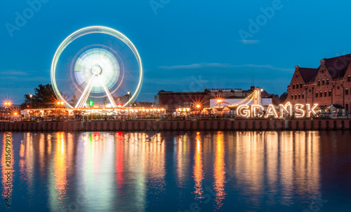 Ferris Wheel at Motlawa river at dusk in Gdansk Poland