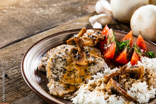 Grilled pork chop with white rice and mushroomson  photo