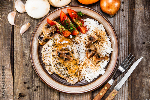 Grilled pork chop with white rice and mushroomson  photo