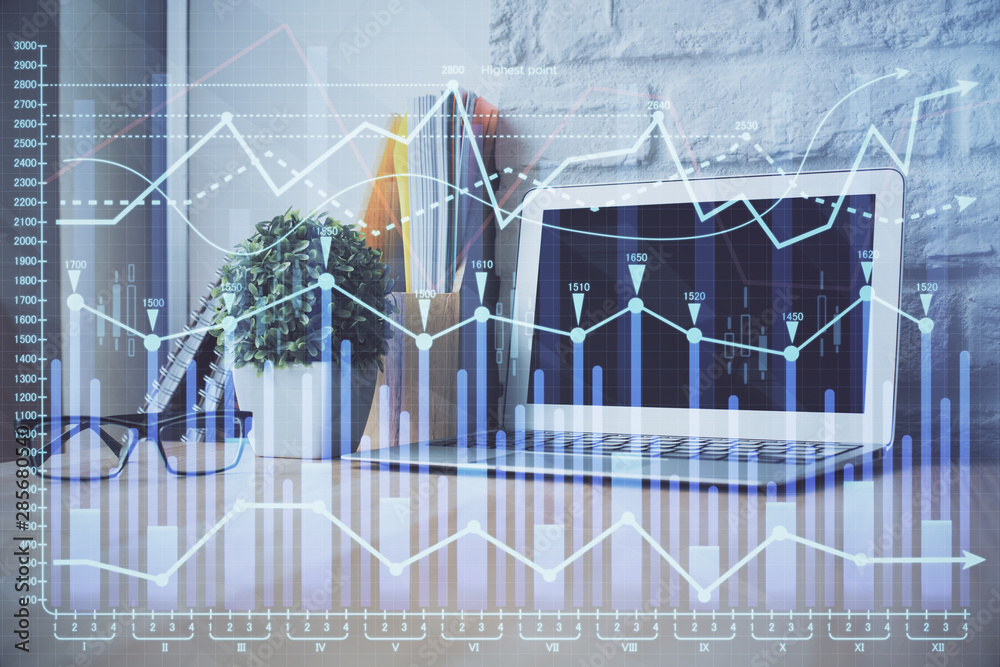 Financial graph colorful drawing and table with computer on background. Multi exposure. Concept of international markets. Financial graph colorful drawing and table with computer on background. Multi exposure. Concept of international markets.