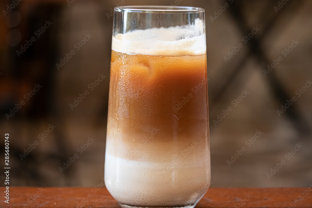 Delicious iced cafe latte on wooden table. Delicious iced cafe latte on wooden table.