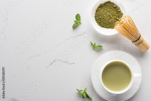 top view of green matcha tea with mint on white table