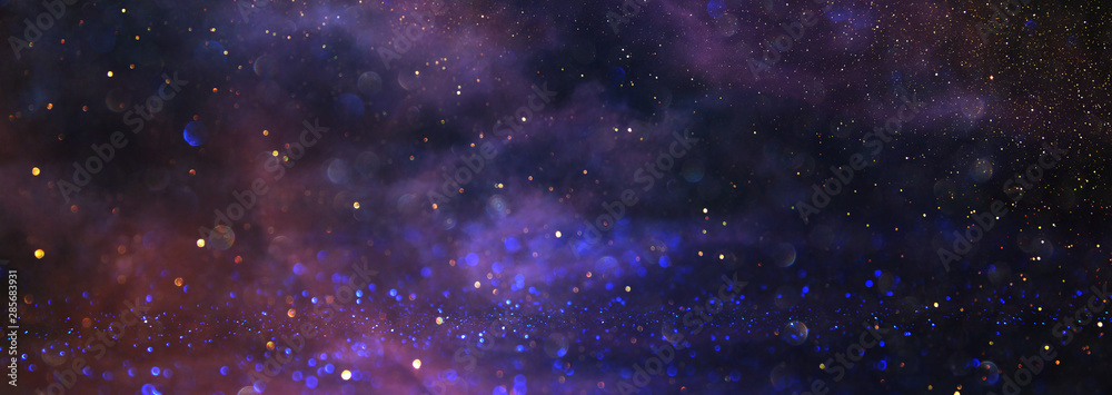 background of abstract glitter lights. blue, purple and black. de focused. banner