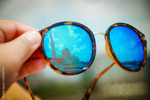 sunglasses on background of blue sky © Pisut