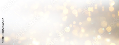 background of abstract glitter lights. silver and gold. de-focused. banner