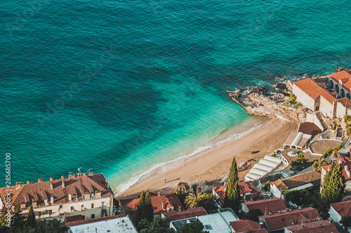 Colorful water on the Adriatic seaside. Top view of Banje Beach in Dubrovnik, Croatia photo