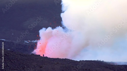 Mount Etna Eruption - Lava flow and ash emission in volcano Etna in Sicily photo