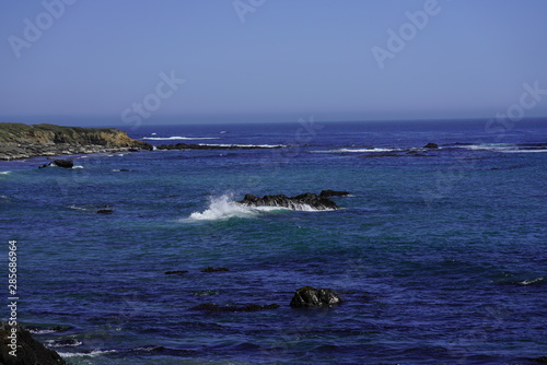Beautiful coastline scenery with ocean waves and rocks cliff on Pacific Coast, California, US