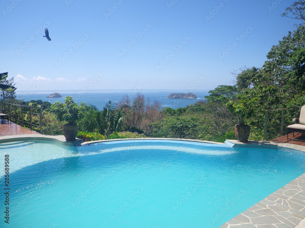 poolside ocean view from luxury vacation spot in tropical rain forest jungle area
