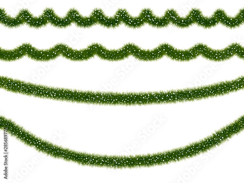 Festive Christmas fir or mistletoe garland covered with snow.