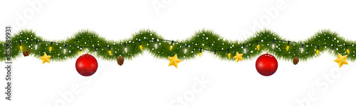 Christmas garland covered with snow. New year tinsel of fir with party lights, christmas balls, golden stars and pine cones.