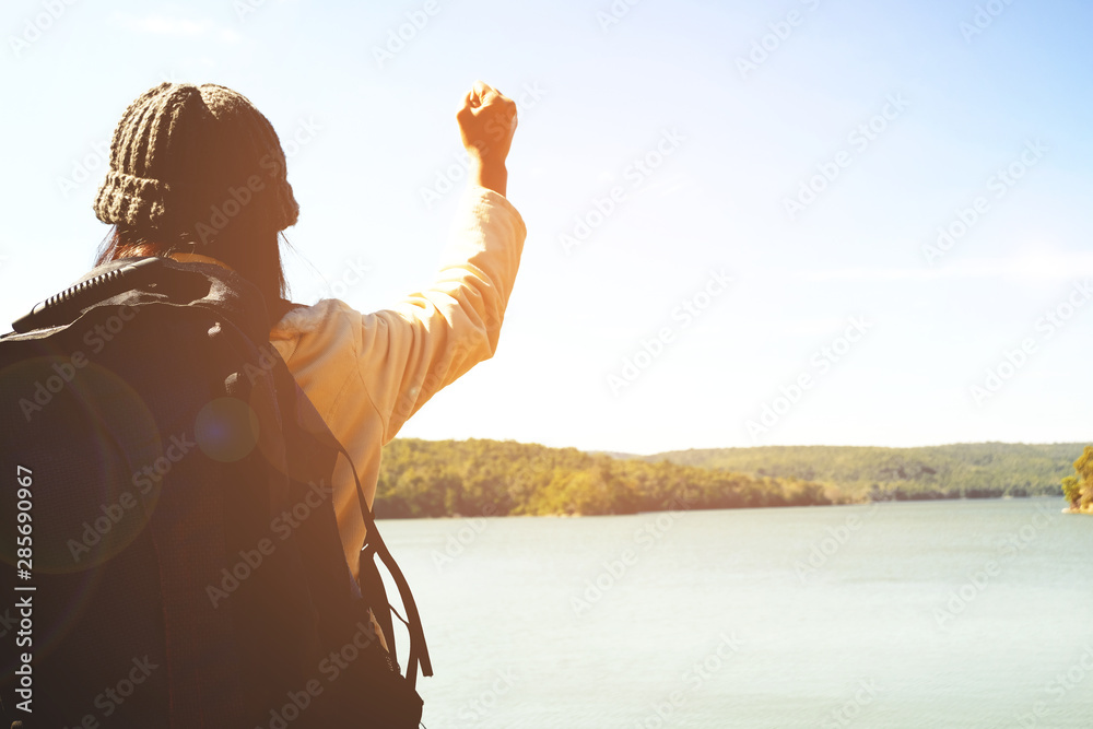 Happy  female with backpack tourist to travel in nature during vacation. Travel concept.