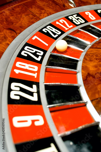 Roulette table in casino  with many games and slots  roulette wheel in the foreground.