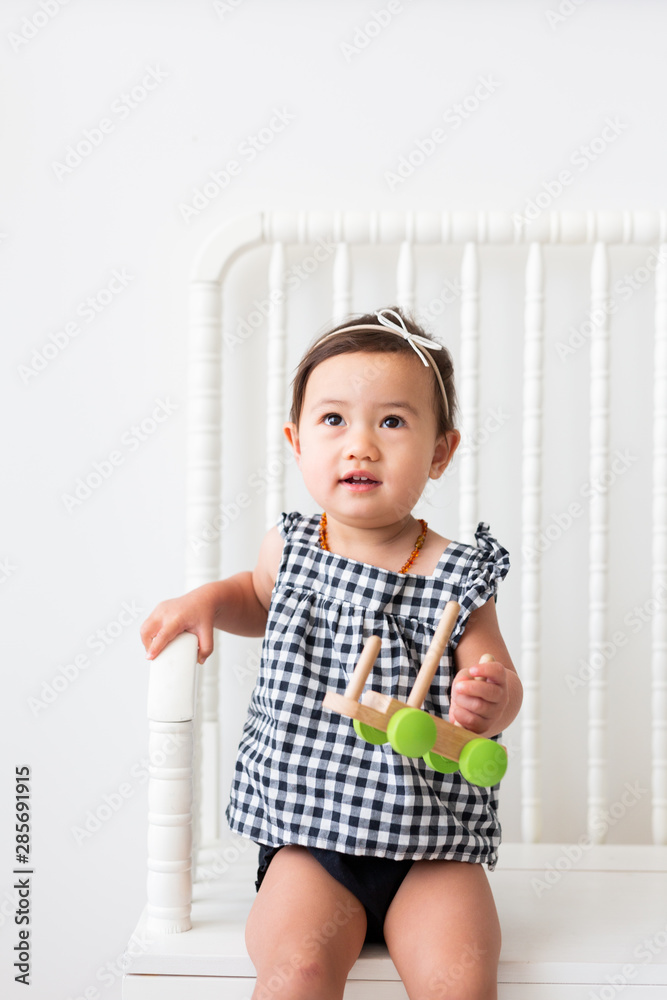 Toddler Girl in Black and White Gingham Romper Stock Photo | Adobe Stock