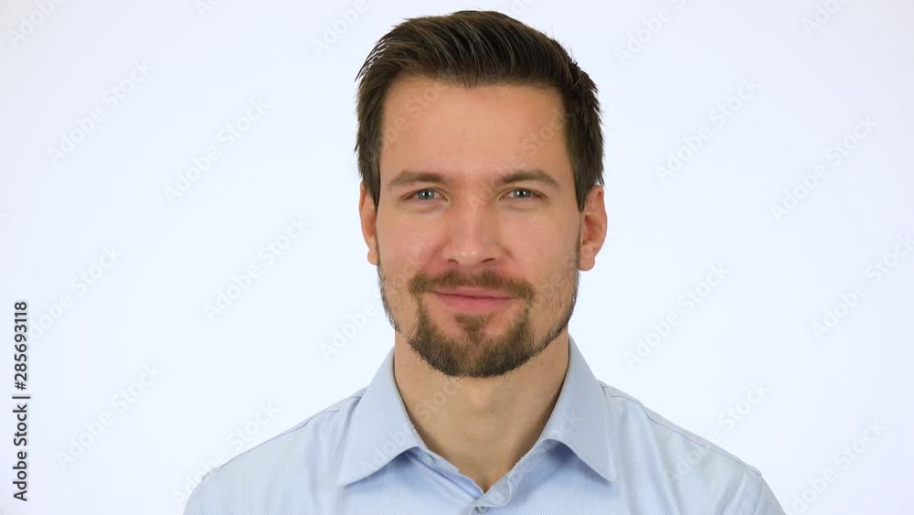 A young handsome man smiles at the camera - closeup - white screen studio A young handsome man smiles at the camera - closeup - white screen studio