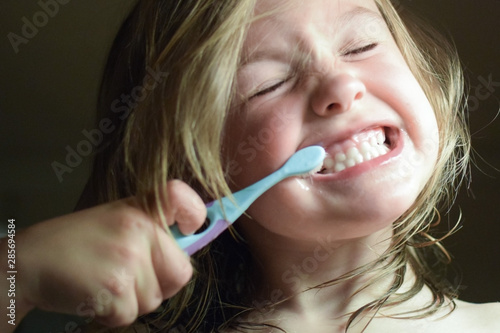 A 5 year old child brushes his teeth. Little girl is brushing her teeth. Selective focus