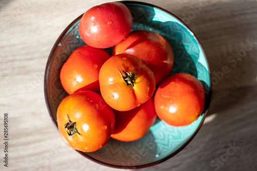 Fresh tomatoes in a plate with drops of water