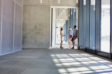 Business people talking in office corridor