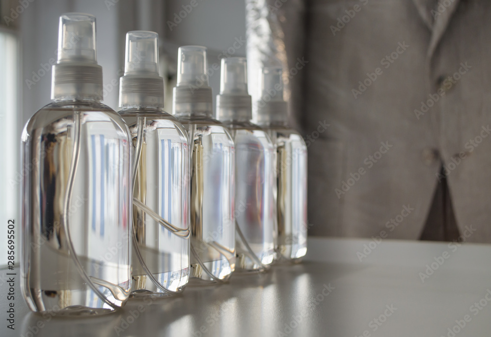 Row of atomizer plastic bottles with clothes fragrance.