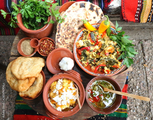 Freshly baked homemade bread arranged in traditional Bulgarian textiles. Image of some tasty Home-made bakery products. Fresh bread,brown, wheat, sliced, round, product, bagel, delicious, baking.