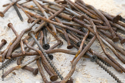 Background of many rusty bent nails and screws. Construction, woodwork, carpentry concept © Irina Kulikova