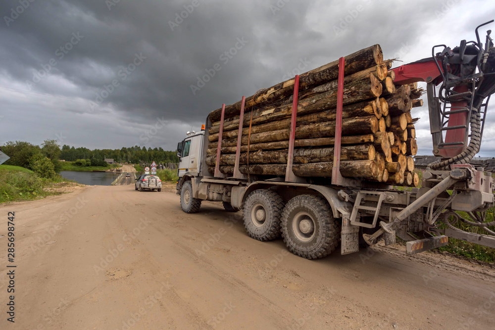 timber truck on a country road in the Arkhangelsk region. Russia