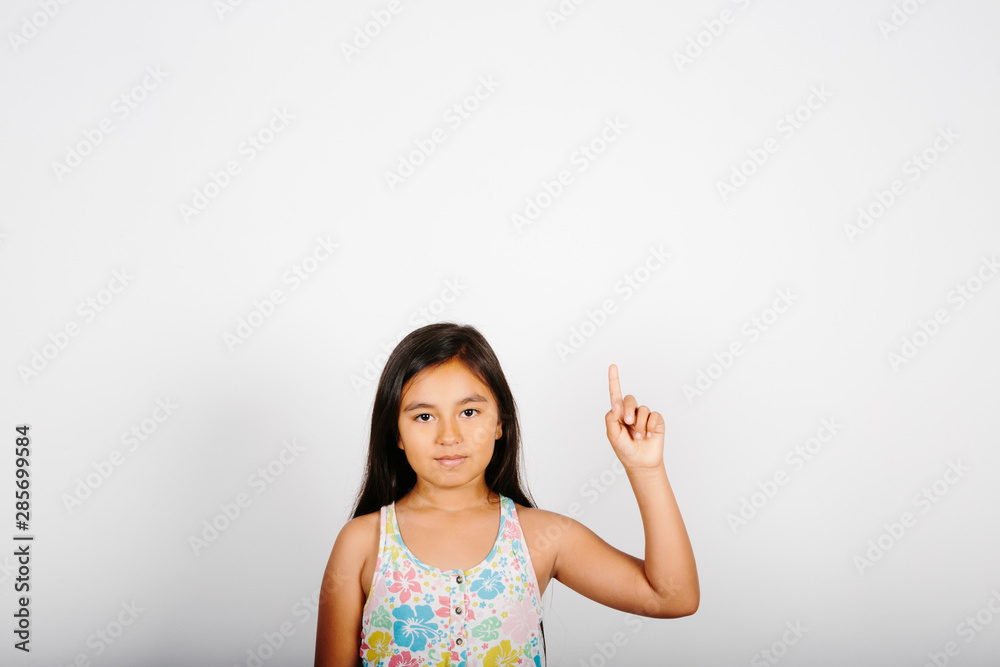 Young girl pointing at the right of the screen on white background. Young girl pointing at the right of the screen on white background.