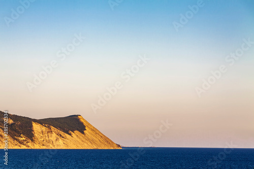 Evening over a high and steep seashore.