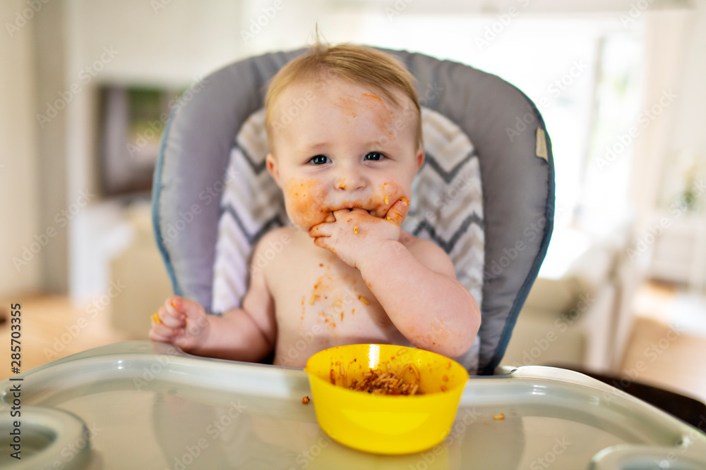 A Little baby eating her dinner and making a mess A Little baby eating her dinner and making a mess