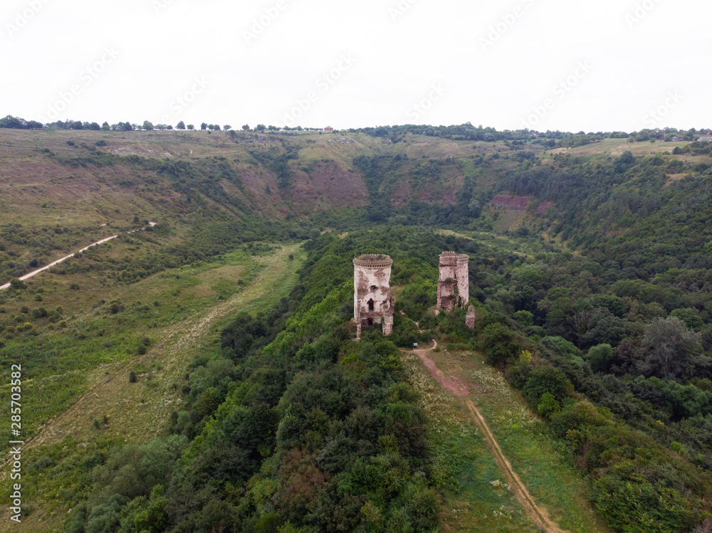 Fototapeta premium Ruins of the castle in Nirkov, towers of the Chervonograd castle, Ukraine. Nirkov, Dzhurin waterfall.