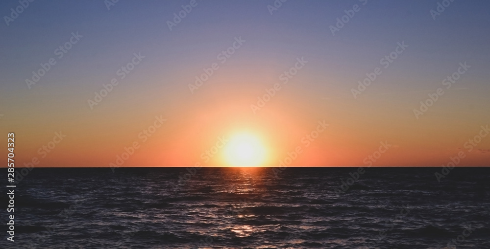 Panorama of beautiful sunset on the ocean.