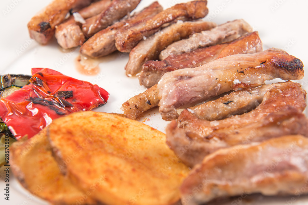 Grilled Secreto of Spanish Iberico pork cut with potatoes and grilled vegetables Grilled Secreto of Spanish Iberico pork cut with potatoes and grilled vegetables